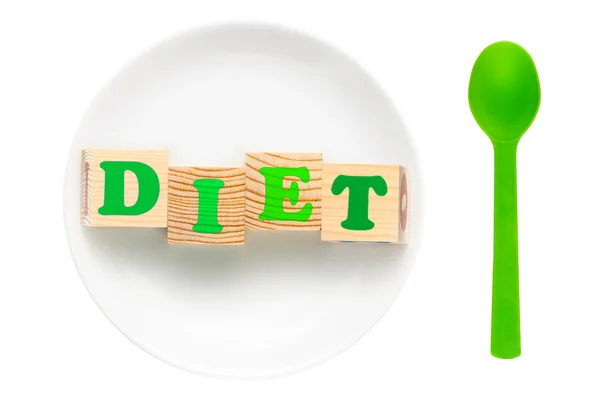 Белая тарелка с зеленым словом диеты — стоковое фото
