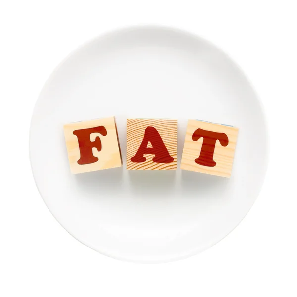 Белая тарелка со словом FAT — стоковое фото