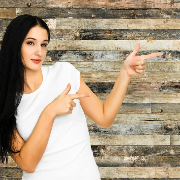 Woman pointing up at copy space — Stock Photo, Image