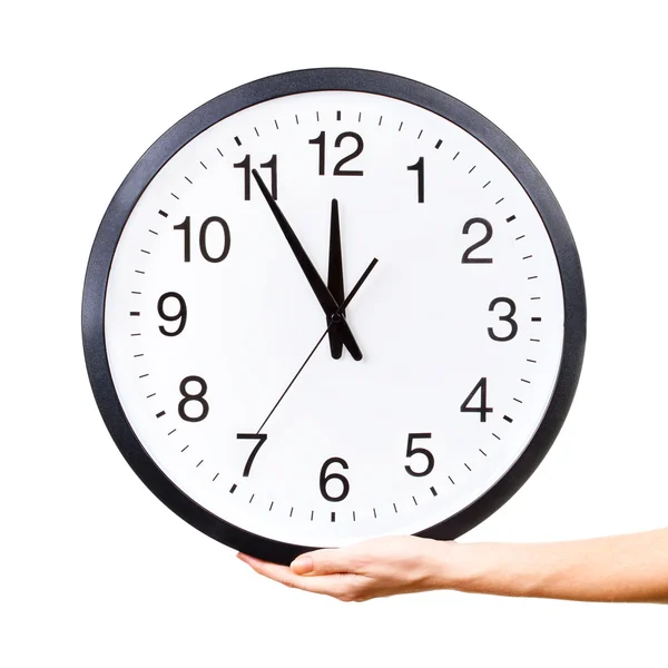 Woman's hand holding a clock Stock Picture