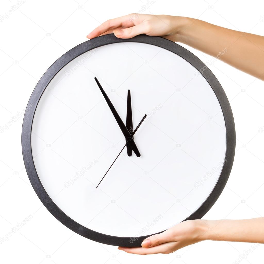 Woman holding a big clock isolated on a white background.