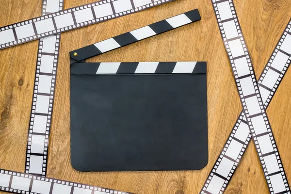 Blank film slate and film stripes — Stock Photo, Image