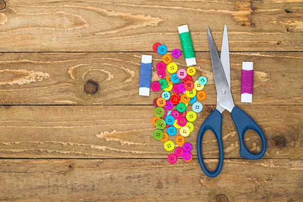 Sewing buttons, scissors and thread rolls — Stock Photo, Image