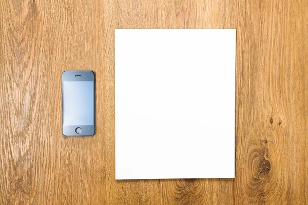 Smartphone and blank paper — Stock Photo, Image