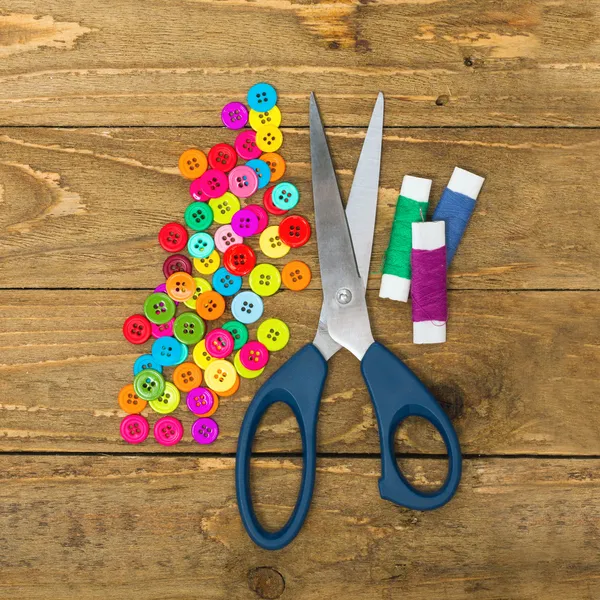 Buttons, scissors and rolls of thread — Stock Photo, Image