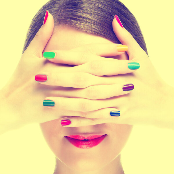 Woman with colorful manicure.