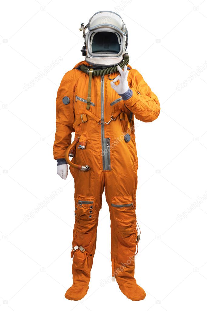 Astronaut wearing an orange spacesuit and helmet showing hand OK sign gesture isolated on white background.