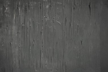Çatlak yüzey dokusuna sahip eski siyah ahşap duvar.