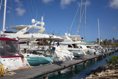 ORANJESTAD, ARUBA - DECEMBER 20, 2020: Sailing and motor boats in the Wind Creek Marina in Oranjestad on the Caribbean island of Aruba (Selective Focus, Focus on the first boats)