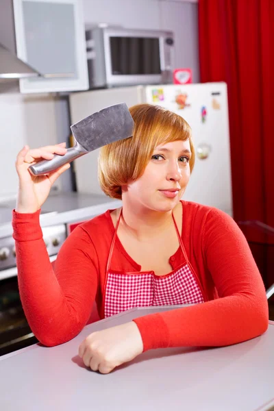 Pretty artful housewife with knife at kitchen — Stock Photo, Image