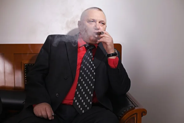 Big boss inhaling cigar — Stock Photo, Image