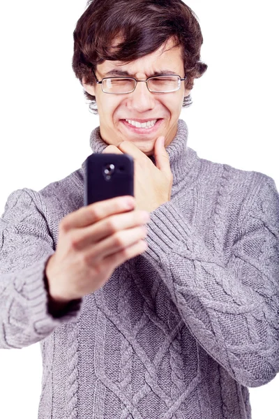 Confused guy shooting on smartphone — Stock Photo, Image