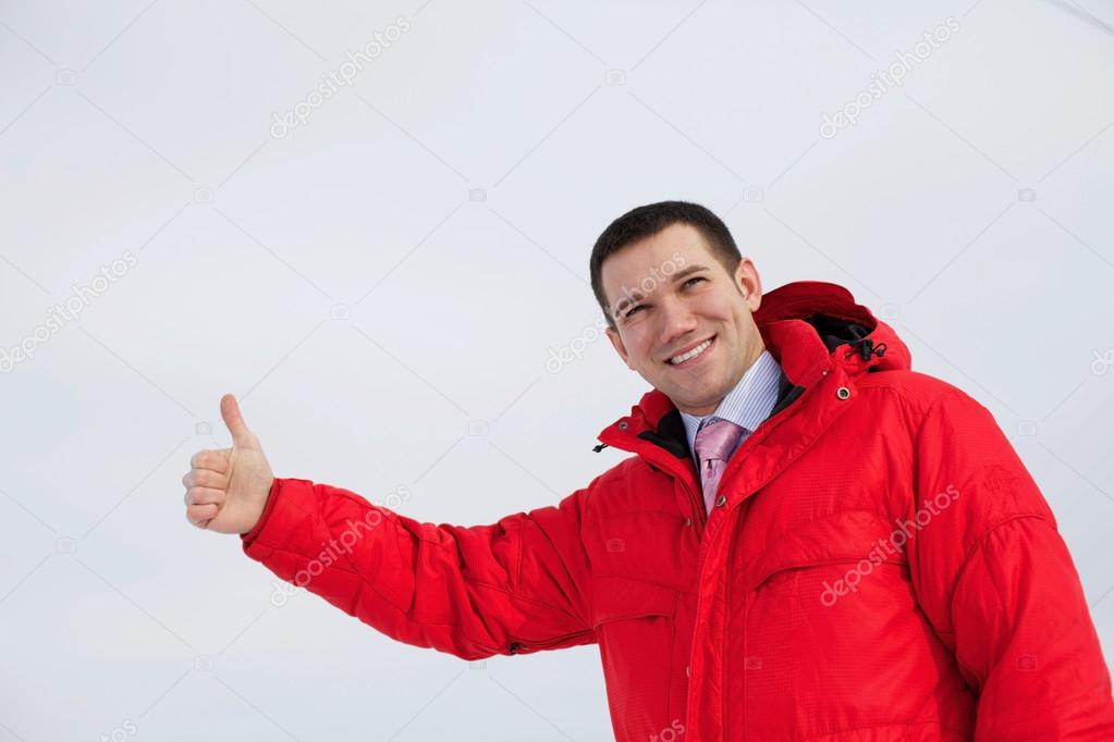Business man shows thumb up outdoor
