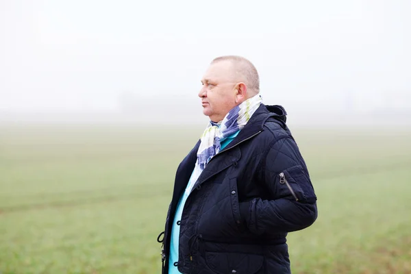 Senior man over foggy field — Stock Photo, Image