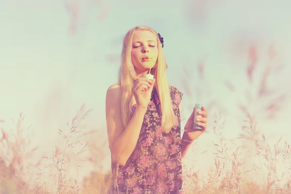 Girl blowing bubbles — Stock Photo, Image