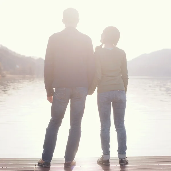 Couple holding hands on berth — Stock Photo, Image