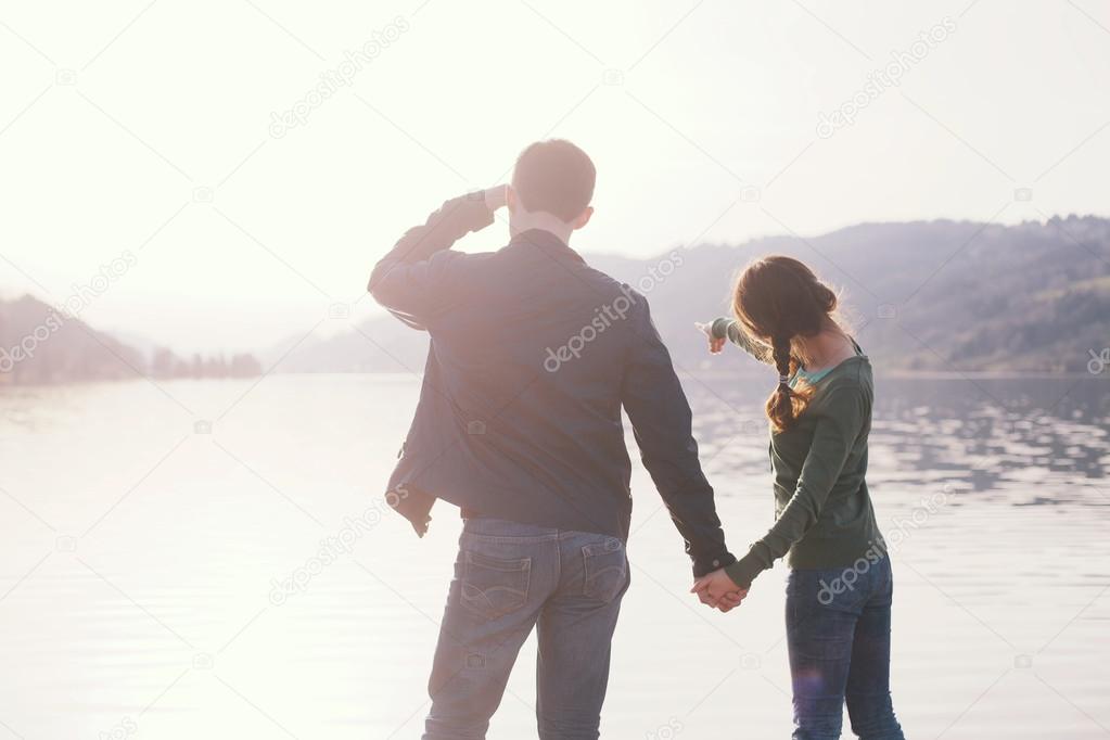 Young couple looking on lake