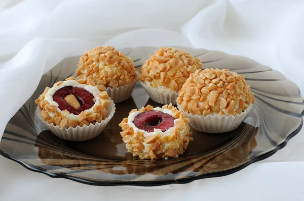 Cheese balls with cherries in peanuts — Stock Photo, Image