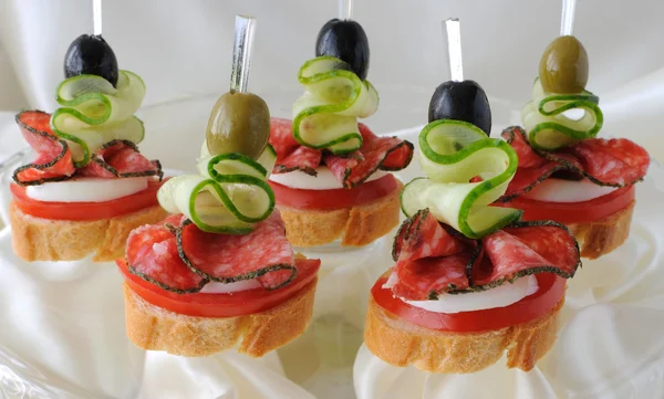 Canapés with salami — Stock Photo, Image