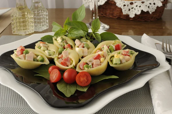 Sea shells pasta stuffed with vegetables and ham — Stock Photo, Image