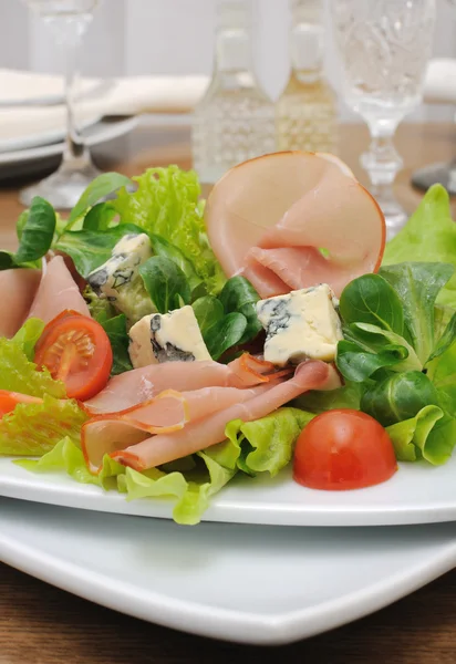 Appetizer with slices of jamon and blue cheese with cherry — Stock Photo, Image