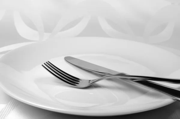 Knife and fork on a plate — Stock Photo, Image