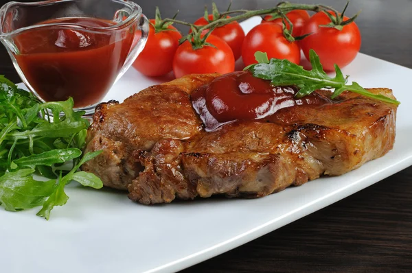 Pork steak with ketchup — Stock Photo, Image