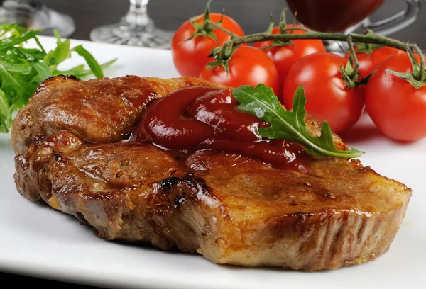 Pork steak with ketchup — Stock Photo, Image