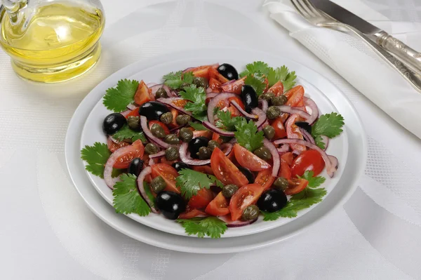 Tomato salad with olives, capers and cilantro — Stock Photo, Image