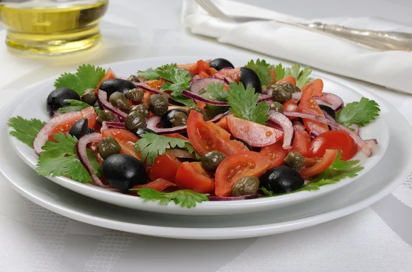 Tomato salad with olives, capers and cilantro — Stock Photo, Image