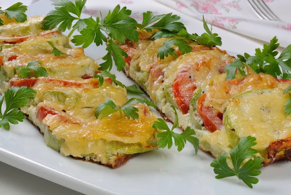 Baked zucchini with tomatoes and cheese — Stock Photo, Image