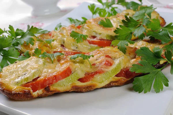 Baked zucchini with tomatoes and cheese — Stock Photo, Image