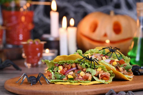 Halloween Food. Mexican corn tortilla tacos with vegetables and chicken. Add some burning gustatory color to your party