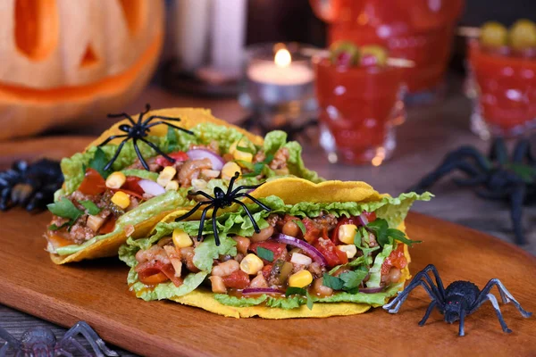 Halloween Food. Mexican corn tortilla tacos with vegetables and chicken. Add some burning gustatory color to your party