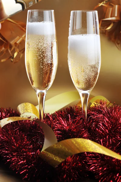 Christmas ribbons and two glasses with champagne — Stock Photo, Image