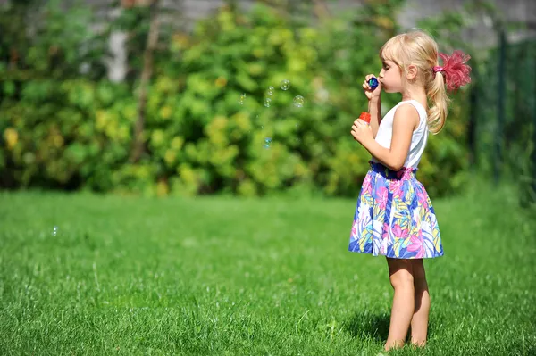 Girl with bubble blower — Stock Photo, Image