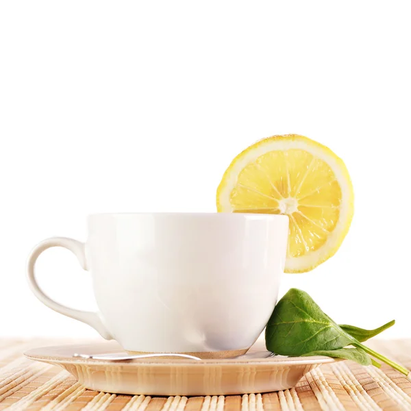 Full cup of tea with lemon Stock Photo