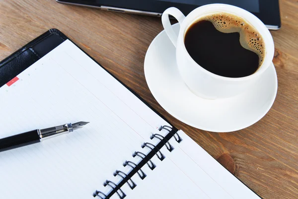 Notebook and cup of coffee — Stock Photo, Image