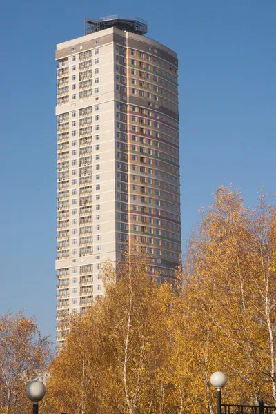 Modern city high building over cloudless blue sky in autumn — Stock Photo, Image