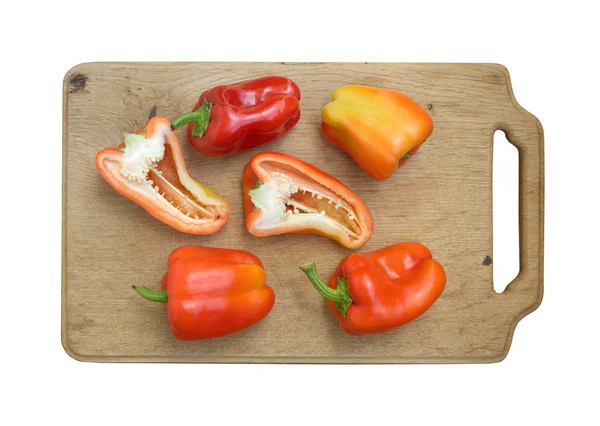 Sweet peppers on kitchen cutting board isolated — Stock Photo, Image