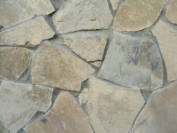 Gray wall with decorative stones in concrete closeup as texture Stock Picture