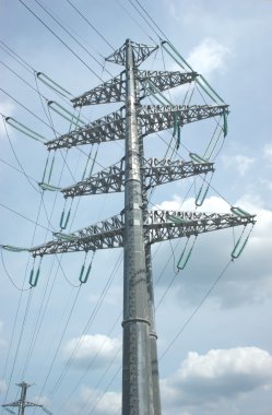 High-voltage power line metal prop over sky with clouds clipart