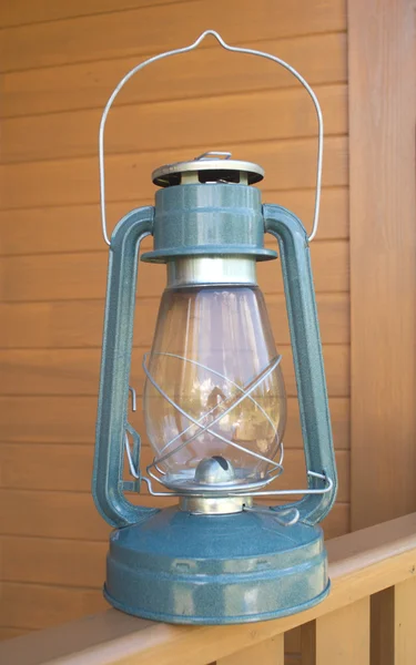 Retro oil kerosene lantern over country house part closeup — Stock Photo, Image