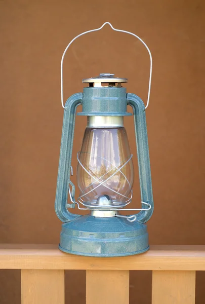 Vintage kerosene lamp on wood fence closeup — Stock Photo, Image