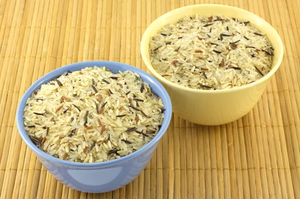 Rice in bowls on mat — Stock Photo, Image