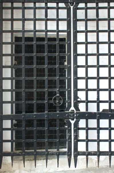 Black strong closed metal gate close up — Stock Photo, Image