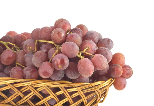 Red grape on branch in straw wicker basket isolated — Stock Photo, Image