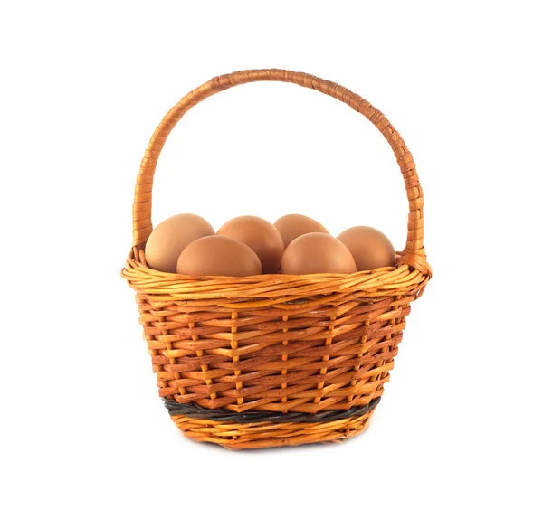 Chicken eggs in wicker basket isolated — Stock Photo, Image