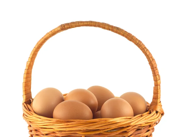 Chicken eggs in wicker basket isolated — Stock Photo, Image