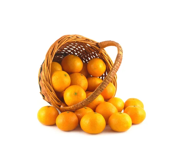 Strewed tangerines from wicker basket lays isolated — Stock Photo, Image